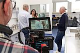 What speaks for us are our employees A cameraman films 2 people in a lab